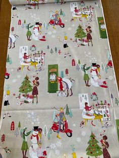 a christmas themed table cloth with people and trees on it