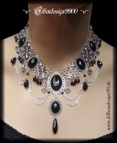 A very elegant choker in gothic style, which, like all my jewelry, was made with great care and attention to detail. The necklace was made from silver-plated metal ornaments with black faceted glass beads and black glass gemstones. Black diamond rhinestones were also used. The chain is adjustable from approx. 39 cm-48 cm, with a black drop hanging on the extension chain. Matching hand jewelry is available in a separate offer. Black Victorian Necklace, Victorian Era Necklace, Gothic Metal Body Jewelry For Party, Black Gothic Metal Necklace, Gothic Costume Jewelry Choker, Silver Vampire Choker For Halloween, Handmade Gothic Body Jewelry For Party, Witchy Black Choker For Gift, Gothic Black Body Jewelry For Party