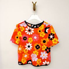 Victoria Beckham For Target Floral Crepe Blouse. Tie Back. Upper Keyhole. Short Sleeves. Relaxed Fit. Semi Cropped Silhouette. Round Trim Edges. Orange With Yellow, Pink, White & Black. Pretty Abstract Flowers. Size Xs Approximate Measurements... Pit To Pit Lying Flat: 17.5” Length: 21” Never Worn, No Flaws To Note. 70s 90s Disco Fun Vibrant Bold Smock Bright Pebble Hippie Bohemian Daisy Boho Pop Art 60s Aperol Spritz Clementine Tangerine Fairy Costume Cute Clown Frill Girly Throwback Retro Prin Vibrant Orange Tops For Day Out, Vibrant Short Sleeve Spring Blouse, Vibrant Short Sleeve Blouse For Spring, Vibrant Cotton Tops For Spring, Retro Orange Printed Top, Orange Vibrant Print Top For Day Out, Vibrant Floral Print Cotton Tops, Vibrant Cotton Floral Print Top, Orange Tops With Vibrant Print For Day Out