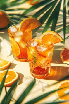 two glasses filled with orange slices and ice