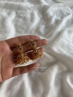 Step into the world of timeless elegance with our Jhumka Earrings. These exquisite earrings are a perfect blend of traditional design and contemporary style, making them a must-have accessory for any occasion. The jhumka style is inspired by traditional South Indian jewelry, known for its intricate craftsmanship and ornate designs. These earrings beautifully capture the essence of Indian culture and heritage, making them a timeless treasure to cherish. Whether you're attending a wedding, festival, or any special event, these Jhumka Earrings will complement your traditional attire flawlessly. They are also versatile enough to add a touch of elegance to your everyday look, making them a versatile addition to your jewelry collection. --------------------------------------------------------- C Elegant Pallu Jhumkas For Diwali, Elegant Navratri Jhumkas, Elegant Earrings For Wedding And Navratri, Elegant Wedding Earrings For Navratri, Fusion Style Earrings For Wedding And Navratri, Fusion Style Jhumkas For Navratri Gift, Diwali Gift Jhumkas With Intricate Design, Diwali Gift Intricate Design Jhumkas, Temple Jewelry Jhumkas As A Gift