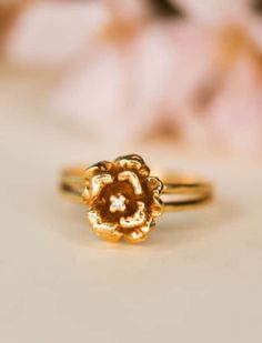 a gold ring with a flower on it