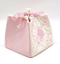 This beautiful soft pink and white bag was sewn in the Japanese style of the Komebukuro technique and quilted with elegant sashiko embroidery. In the past Komebukuro bags were used in Japan to store rice, so it sits on the ground nicely and has a pretty shape when filled. You can use it as a storage bag for knitting utensils, cosmetics, grain and all sorts of other things, or as a bag to transport your wallet or lunch box. The perfect accesoire for festivities like the wedding! Please indicate t Pink Square Pouch For Daily Use, Pink Square Pouch For Gift, Pink Embroidered Pouch For Gift, Embroidered Pink Pouch For Gift, Embroidered Pink Pouch For Gifts, Embroidered Pink Pouch As Gift, White Embroidered Rectangular Pouch, Embroidered White Rectangular Pouch, Traditional Pink Rectangular Pouch