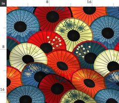 many colorful umbrellas are arranged together in this pattern, and the background is very vibrant