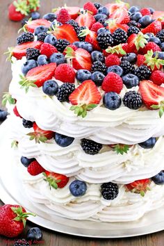 a white cake with strawberries and blueberries on top