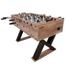 an old wooden foosball table with black and white chess pieces on it's legs