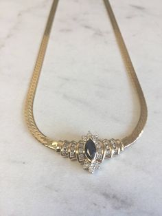 "An incredible 14kt Yellow Gold Lady's Diamond and Sapphire Necklace in 16\" consisting of 1- 8mm x 4m .75ct approx. total weight Genuine Marquise Sapphire with .50ct total weight of diamonds SI1/SI2 clarity, G color prong and channel set surrounding the gemstone with a flat 4mm Herringbone style chain with a heavy box clasp. This show stopper will lighten up any evening when worn. Sapphire is the Birthstone for September. The total weight of this Necklace is 14.5 grams. This item would Retail f Formal Marquise Gemstone Necklace, Marquise Gemstone Necklace For Formal Occasions, Gold Marquise Diamond Necklace With Accents, Elegant Diamond Custom Necklace For Formal Occasions, Gold Marquise Diamond Necklace For Formal Events, Formal Marquise Necklaces With Diamond Accents, Luxury Formal 14k Stamped Necklaces, Formal Marquise Necklace With Diamond Accents, Elegant Custom Diamond Necklace For Formal Occasions