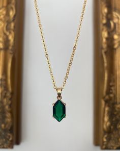 Gold-plated emerald green hexagon jewel necklace. The pendant measures 1.6 cm x 0.9 cm. Hung on a gold-plated chain which measures 45.7 cm (18 inches). Comes in a black velvet cushioned box as seen in last photo. Free of charge. Matching earrings available here.... https://www.etsy.com/uk/listing/1236754577/emerald-green-hexagon-jewel-huggie-hoop?ref=listing_published_alert INTERNATIONAL BUYERS please choose the tracking option if you would like your order to be tracked. FREE tracking upgrade wi Octagon Emerald Gold Jewelry, Emerald Octagon Necklace For Gift, Green Octagon Necklaces As Gift, Green Octagon Necklace For Gift, Jewel Necklace, Emerald Necklace, Velvet Cushions, Jewelry Plate, Matching Earrings