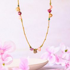 Infuse your style with the free-spirited elegance of our Boho Baroque Pearl Chain Necklace, a piece that effortlessly combines modern bohemian charm with timeless sophistication. This necklace features a unique arrangement of baroque pearls, each with its own distinctive shape and iridescent hue, set along an 18K gold-plated brass chain. The pearls, in shades of pink, gold, and deep purple, are interspersed with delicate green enamel beads, creating a vibrant and harmonious design. The asymmetri Elegant Festival Necklaces With Delicate Chain, Bohemian Chain Necklace Gift, Bohemian Chain Necklace For Gift, Elegant Festival Necklace With Delicate Chain, Bohemian Charm Necklaces With Chain For Gift, Bohemian Gold Charm Necklace With Colorful Beads, Gold Bohemian Charm Necklace With Colorful Beads, Bohemian Gold Charm Necklaces With Colorful Beads, Bohemian Gold Beaded Necklaces With Delicate Chain