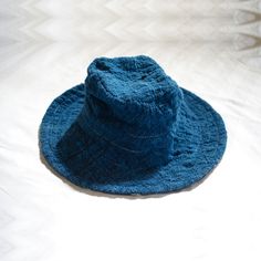 A reversible bucket hat inspired by the wide-brimmed floppiness of fantastical wizard hats, alluding to a connection to another invisible world that may grant protection and safe passage on a voyage. The + symbol, or tapak dara, often painted at the front gates of homes in Bali, is believed to ward off troublesome spirits. 100% handwoven organic cotton 100% hand painted batik 100% botanical dyes GOTS certified organic cotton sewing thread Cut and sewn with care in Bali Limited stock available fo Wizard Hats, Reversible Bucket Hat, Front Gates, Botanical Dyeing, Hats For Sale, Sewing Thread, Limited Stock, Leaf Tattoos, Wide Brimmed