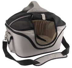 a white and black pet carrier with a cat in it's back pocket on a strap