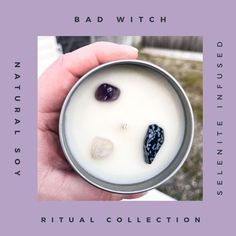 a person holding a candle with rocks in it and the words bad witch written on it