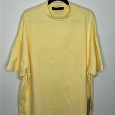 Fear Of God Essentials Heavy Jersey Crewneck T-Shirt Oversized Yellow Men’s Small. Nwt. Oversized Yellow Top For Streetwear, Yellow Oversized Top For Streetwear, Oversized Yellow Letter Print Tops, Oversized Yellow Tops With Letter Print, Yellow Oversized Graphic Tee, Urban Yellow Short Sleeve Top, Yellow Urban Short Sleeve Top, Spring Streetwear Drop Shoulder Tops, Yellow Short Sleeve Urban Top