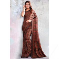 Look elegant when wearing this dark brown crepe saree which will make you absolutely astoundingly gorgeous. This round neck and sleeveless blouse is accentuated with printed work. It is available with a crepe lightweight saree in dark brown color with printed work. This blouse can be customized up to the maximum size available in inches 44 around the bust. Slight color variation may occur due to photographic reasons. Dark Brown Color, Indian Sarees