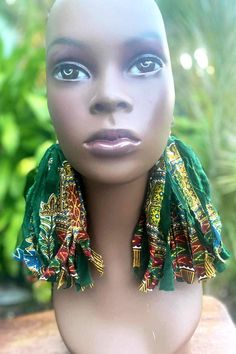 Step into a world of cultural elegance with our 7 1/2-inch shredded Dashiki cloth earrings in green. Embrace your individuality with our unique Afrocentric jewelry, featuring tassel and fringe details that add a playful flair to your style. Handmade Green Tassel Earrings For Festival, Green Tassel Earrings With Fringe For Festivals, Bohemian Green Tassel Earrings For Festivals, Adjustable Green Tassel Earrings, Green Fringe Earrings For Festival, Traditional Green Tassel Earrings, Bohemian Green Tassel Fringe Earrings, Green Bohemian Tassel Earrings With Fringe, Bohemian Green Tassel Earrings With Fringe