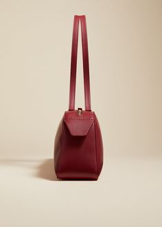 Description An elongated silhouette that unites lines with curves. Topped by sleek, doubled straps and a custom zipper. Card pocket at suede-lined interior. Details Material: Soft smooth calf (100% calfskin) Care: Clean professionally by leather expert Origin: Made in Italy Burgundy Evening Shoulder Bag With Leather Lining, Evening Burgundy Shoulder Bag With Leather Lining, Classic Structured Shoulder Bag, Formal Burgundy Shoulder Bag With Leather Lining, Chic Burgundy Shoulder Bag With Leather Lining, Formal Structured Shoulder Bag With Leather Lining, Classic Evening Shoulder Bag With Leather Lining, Classic Burgundy Bag With Zipper Closure, Elegant Burgundy Leather Shoulder Bag