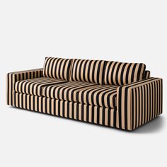 a black and white striped couch sitting on top of a wooden floor