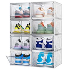 four clear bins filled with different types of shoes on display in front of a white background