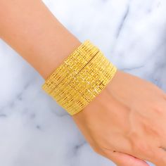 Indulge in luxury with our Royal Floral Checkered 22K Gold Bangle Set. Crafted in 22k gold, this exquisite set features a total weight of 92.5g, radiating opulence. The captivating floral checkered design and lustrous yellow gold finish make it a statement of high fashion. Bangle Size 2.7 with a 2.45" diameter opening. Set includes 6 stunning bangles PRODUCT DETAILS Gold Purity(karat): 22k Gold Weight(grams): 92.5 Item Finish: Yellow Gold Bangle Size: 2.7 Bangle Opening(diameter): 2.45" Number O Yellow Gold-plated Bracelets For Wedding, Yellow Gold Plated Bracelets For Wedding, Yellow Gold-plated Bangle As Gift, Yellow Gold-plated Bangle For Gift, Yellow Gold Plated Bangle As A Gift, Yellow Gold Plated Bangle For Gift, Luxury 22k Gold Yellow Jewelry, Yellow Gold-plated Bangle Jewelry, Yellow Gold-plated Bangle Bracelet