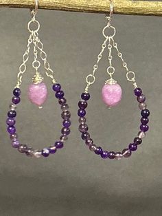 Artisan designed and handcrafted making these earrings are one of a kind. Purple and lavender amethyst wire wrapped beads. These earrings are dangling down the sterling silver chain. These purple amethyst are making a bead hoop. Lavender amethyst large beads are wire wrapped and dangling on a sterling silver chain attached to the lever back earring wire. This pair of earrings are a great presentation of a hoop earring. These earrings are a perfect gift. Total measurement 3 inches long including Handmade Chandelier, Lavender Amethyst, Earrings Dangling, Large Beads, Earring Wire, Beaded Hoops, Artisan Design, Style Earrings, Silver Earrings Dangle