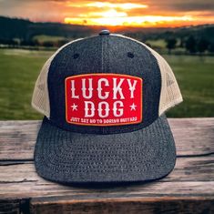 The Lucky Dog black Denim Trucker Hat offers a unique blend of style and comfort. Its trucker mesh-back design provides a comfortable fit and the Black Denim/Khaki color combination adds a modern edge. Perfect for a range of outdoor activities, it stands out whatever the occasion.  Contents: 35% Cotton / 65% Polyester Sizes: One Size Fits Most Profile: Mid Crown: 3 1/2" Visor: Curved Panels: 6 Panels Additional Features: Classic shape. Premium cotton-poly fabric. Matching plastic snap. Hard buck Trucker Baseball Cap With Letter Patch For Outdoor, Outdoor Trucker Baseball Cap With Letter Patch, Trucker Snapback Hat With Logo Patch, Trucker Style Snapback Hat With Logo Patch, Trucker Baseball Cap With Patches For Outdoor, Trucker Style Baseball Cap With Patches For Outdoor, Black Trucker Baseball Cap For Rodeo, Black Flat Bill Trucker Hat For Rodeo, Trucker Baseball Cap With Leather Patch