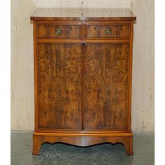 an antique wooden cabinet with two doors