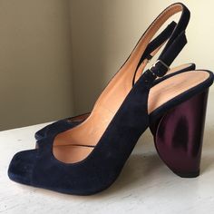 New And Unworn. Purchased At Sample Sale. Fits Like A Size 6. Shoe Is Navy Suede. Sculptural Half Circle / Heel Is Metallic Purple. 3.75” Heel Height. Note - Right Shoe Is 36.5 And Left Shoe Is 36. They Look The Same Size When I Compare Side By Side And They Feel The Same When I Wear Them. It’s Possible My Right Foot Is Slightly Bigger Than My Left. Purple High Heel Slingback Pumps For Summer, Summer Purple Slingback Heels, Purple Slingback Heels For Summer, Designer Blue Slingback Pumps For Evening, Elegant Purple Sandals With Branded Heel, Chic Purple Slingback Heels, Formal Purple Sandals With Heel Strap, Purple High Heel Slingback Pumps, Purple High Heel Slingback Pumps With Heel Strap