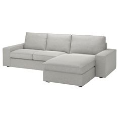 a white couch with a chaise lounge on it's left arm and footrests