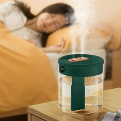 a woman laying in bed with her head on the pillow next to a humidifier