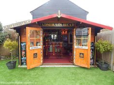 the entrance to an outdoor bar with wooden doors