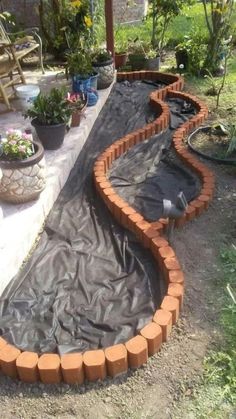 an outdoor garden area is being constructed with bricks and tarp to protect it from the sun