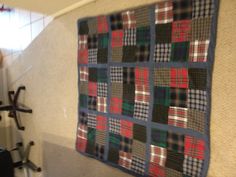 a patchwork rug is on the floor in front of a computer desk and chair