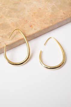 Gold threader hoop earrings go with everything! Elegant and lightweight enough for everyday wear. Dimensions: 1.5 x 1" (4 cm) Materials: Copper, 18k Gold Plating Ships in a branded jewelry pouch and box, perfect for gift giving! Jewelry Pouch, Gift Giving, Gold Plating, 18k Gold, Everyday Wear, Gold Plate, Hoop Earrings, Copper, Plating