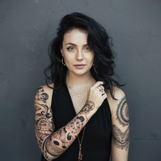 a woman with tattoos on her arms and arm