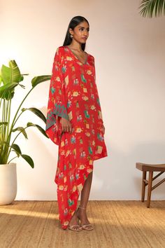 Introducing an elegant asymmetrical kaftan, designed for effortless style and comfort. With its flattering v-neckline and bell sleeves, this kaftan exudes a timeless charm. The printed border details on the sleeves and neckline add a touch of sophistication and flair, elevating the overall look. Paired with a coordinating slip for added coverage and versatility, this kaftan is perfect for lounging by the pool or enjoying a leisurely day out. The Pool, Effortless Style, Bell Sleeves, Overalls, Pool, Red, Design