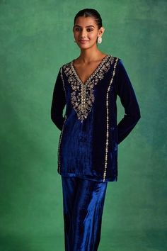 Blue silk velvet kurta featuring embroidered floral motifs highlighted by sequin, pearl, mirrorwork and crystal embellishments. Comes with matching pant highlighted by lace embellishments and embroidered scalloped hem dupatta. - Aza Fashions Velvet Kurta Pakistani, Velvet Indian Outfits, Blue Suits Women Indian, Velvet Suits Women Indian, Velvet Suit Design, Editors Note, Velvet Kurta, Angrakha Style, Kurta Pant Set