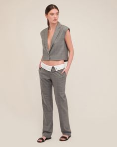 Cut in a smooth luxurious wool, the Dana is structured yet lightweight and features a daring deep V neckline. This vest effortlessly transitions from desk to dinner, ensuring you move through your day with confidence. Style the Dana with the Leo Foldover Waist Trouser for a hook up that embodies modern suiting with a touch of downtown edge. Easy fit Deep V neck Notch collar with traditional blazer details Single breasted, button closure Sleeveless Dropped armholes Light shoulder pad Fully lined Fitted V-neck Vest For Office, Elegant V-neck Vest For Office Wear, Elegant Tailored Vest For Office Wear, Tailored Notch Lapel Vest For Office, Tailored Blazer With Vest For Office, Sleeveless Vest For Office Wear In Fall, Fitted Sleeveless Blazer For Office, Office Vest With Notch Lapel And Tailored Fit, Classic V-neck Office Vest