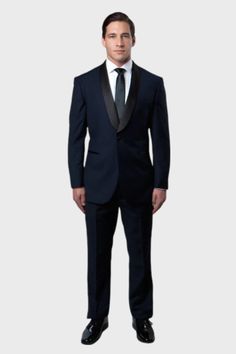 This navy tuxedo is excellent to wear for any formal occasion with its narrow shawl collar and single-button closure. The collar is a true shawl style with no notch. The lapel is faced in a subtle satin material for contrast. The jacket has a low-cut front that can be worn with a vest or without. The flat front pants have a straight leg cut that won't go out of style. Details: Includes: Tuxedo Jacket, and Pants JACKET: Full Lined,1 Button closure, Satin Shawl Lapel. Side Vents PANTS: Flat Front