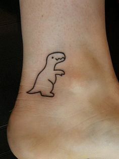 a small dinosaur tattoo on the ankle