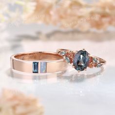 two wedding rings with blue and white diamonds on them, one is in rose gold