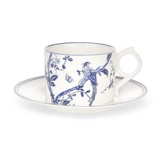 a blue and white tea cup with saucer on the side, sitting on a plate