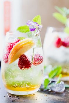 champagne and peach sangria in a pitcher with fresh fruit garnish on the rim