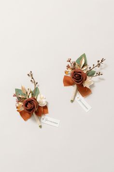 two boutonniers with flowers and leaves on them