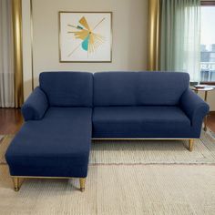 a blue couch sitting on top of a rug in a living room next to a window