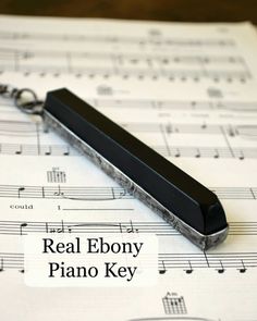 a black object sitting on top of sheet music