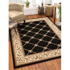 a black and white rug with gold trimmings on the floor in front of a chair