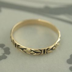 "Gold Antiqued Ring~Gold Wedding Band~Orange Blossom Ring~Romance Band~Antiqued Gold Band~Black Gold Ring~Women Gold Ring~Vintage Style Ring Introducing our new ANTIQUED Gold Bands! This solid 14K gold ring is hand crafted from preformed pattern wire. It features a lovely floral design and can be custom made in any ring size. The detail is so exquisite it looks as if it was hand engraved! Measuring 2.8mm (just under 1/8\") wide and a slim .75mm thick, it is perfect as a petite wedding ring or st Vintage Yellow Gold Band Ring, Ornate Ceremonial Rings With Decorative Band, Ceremonial Ornate Rings With Decorative Band, Vintage Yellow Gold Wedding Bands, Vintage Round Band For Promise Ring, Vintage Stackable Wedding Rings Round Band, Vintage Round Band Promise Ring, Antique Black Engraved Wedding Ring, Vintage Black Engraved Wedding Ring