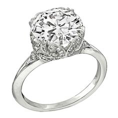 a diamond engagement ring with an oval center stone