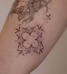 a woman's arm with a tattoo design on the left side of her body