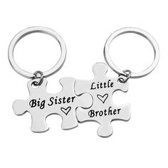 two pieces of puzzle keychain with the words big sister and little brother on them